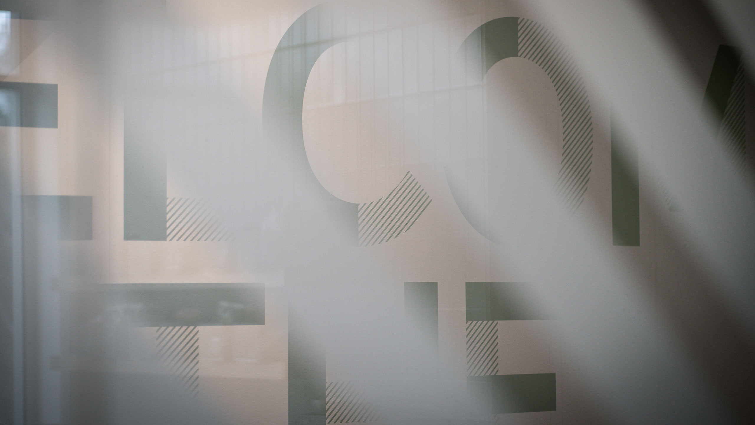 Our custom font shown behind the glass stripes