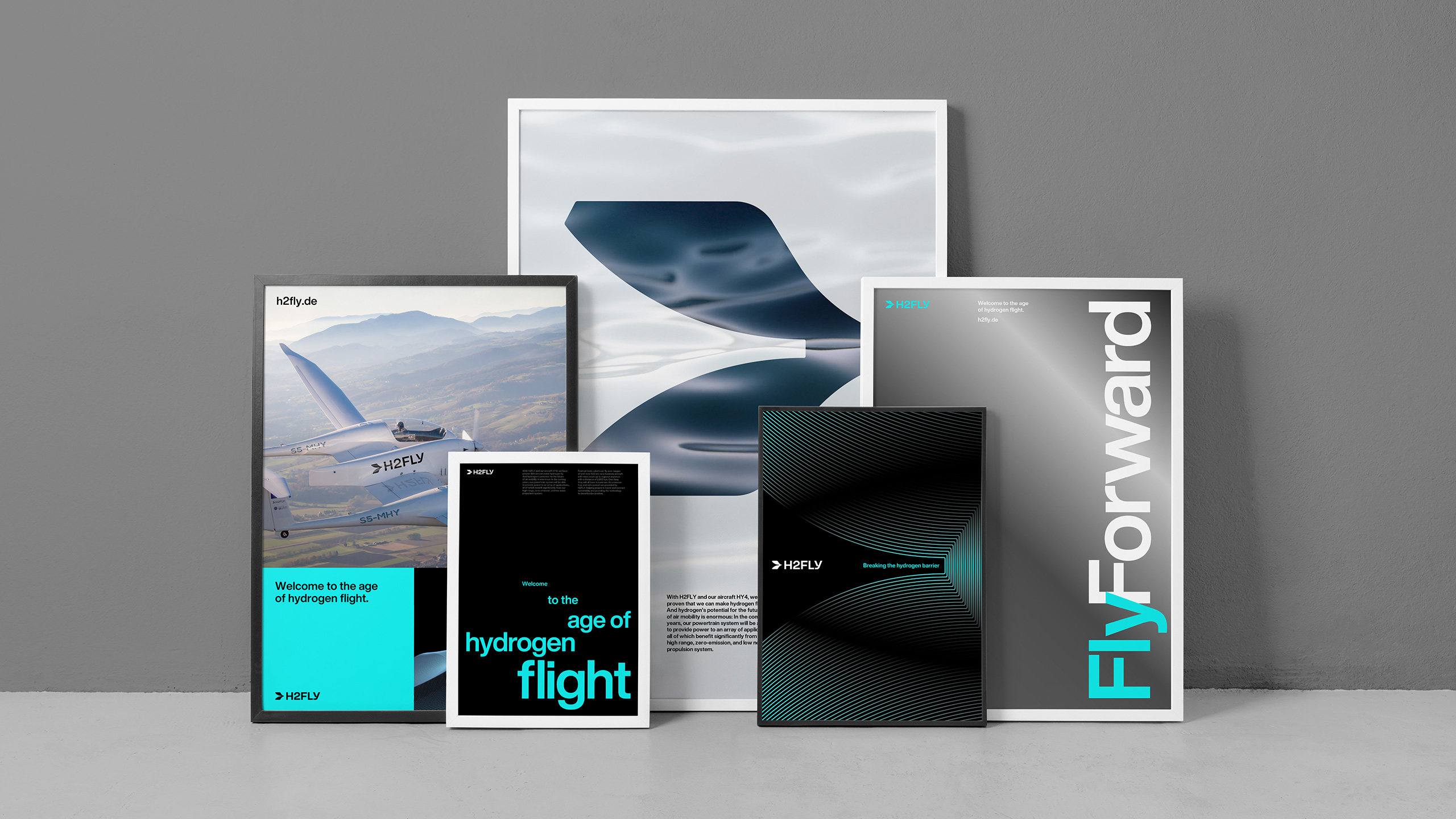 H2FLY hydrogen aviation posters displayed on a concrete wall, featuring futuristic typography and branding for sustainable flight.